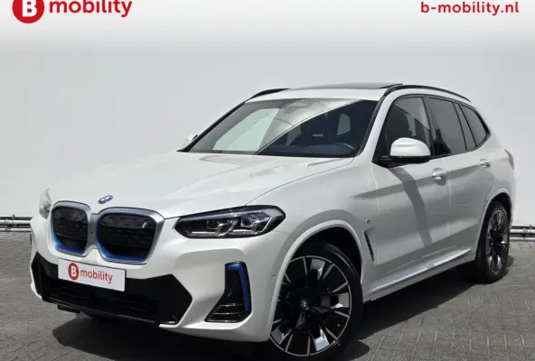 High Executive M-Sport 80 kWh SOH 98% 'Mineral-Weiss' Trekhaak Panoramdak Harman/Kardon | Adaptive Cruise Control | Elek. Stoelen | Head-Up | DAB