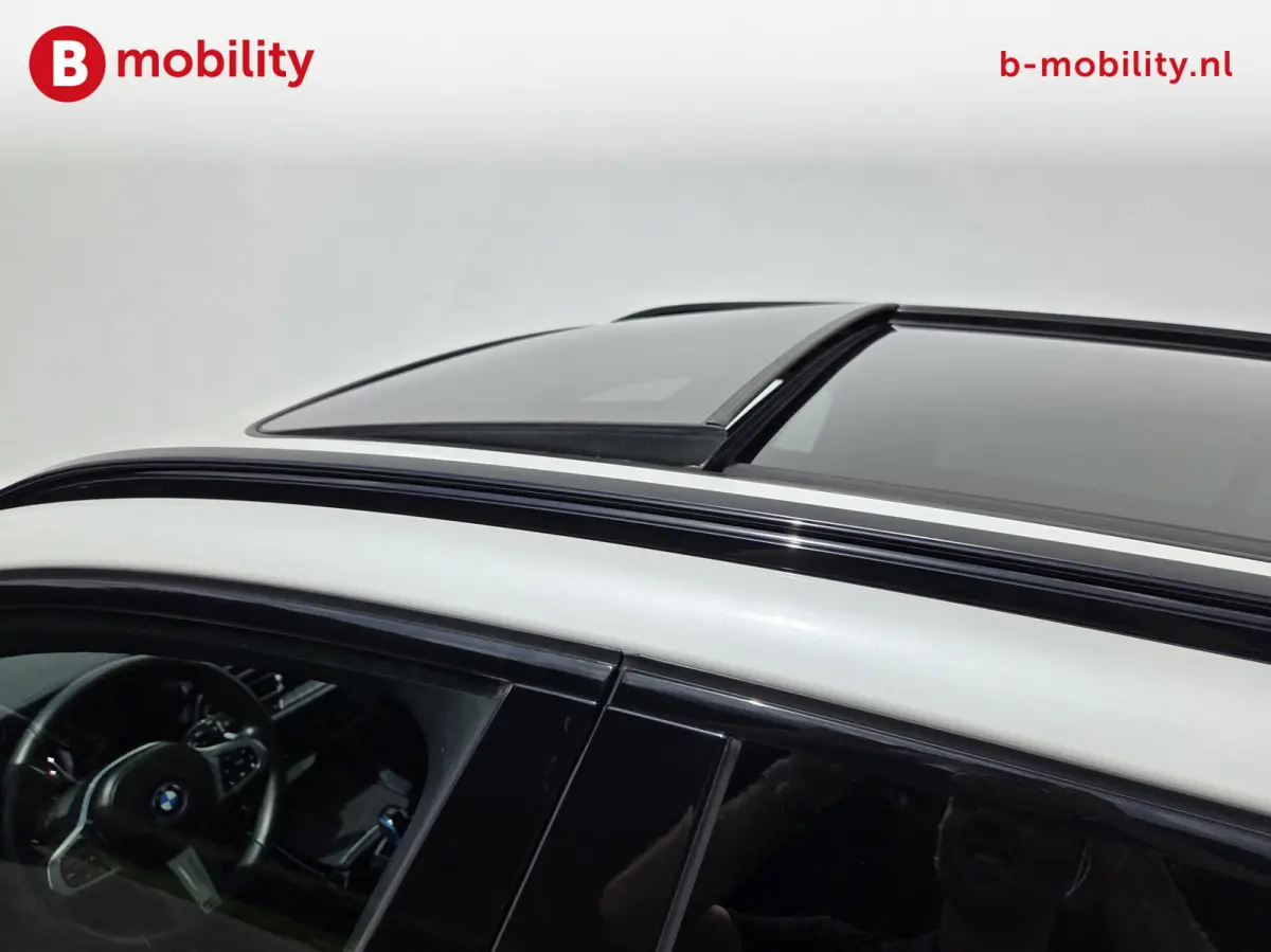 High Executive M-Sport 80 kWh SOH 98% 'Mineral-Weiss' Trekhaak Panoramdak Harman/Kardon | Adaptive Cruise Control | Elek. Stoelen | Head-Up | DAB