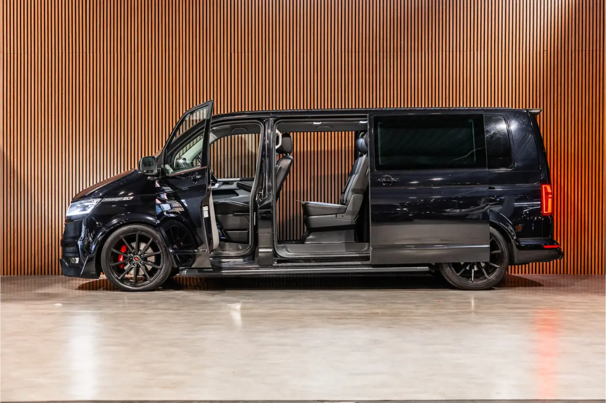 2.0 TDI L2H1 DC Caravelle | LeightonVans Bodykit | ACC | Bi-Xenon | Elek deuren | Lederen bekleding | Camera | CarPlay | Navigatie | Trekhaak | Nieuwe APK