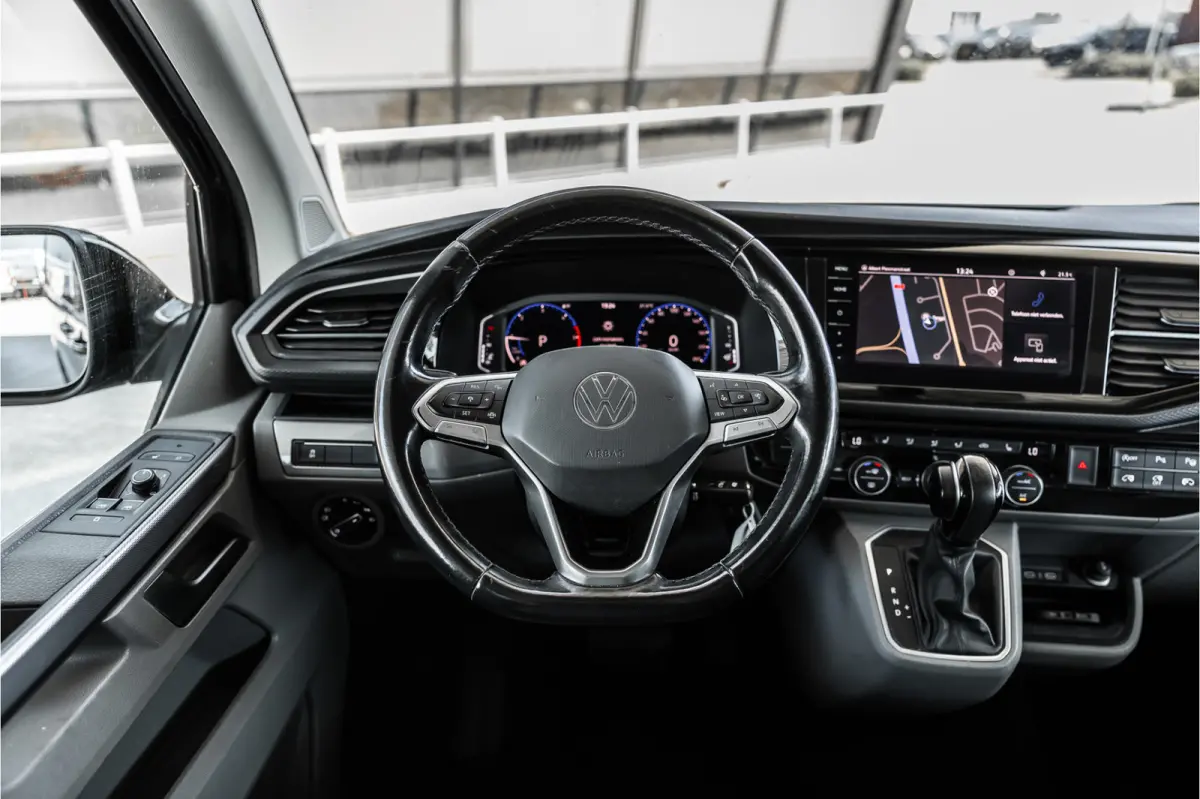 2.0 TDI L2H1 DC Caravelle | LeightonVans Bodykit | ACC | Bi-Xenon | Elek deuren | Lederen bekleding | Camera | CarPlay | Navigatie | Trekhaak | Nieuwe APK