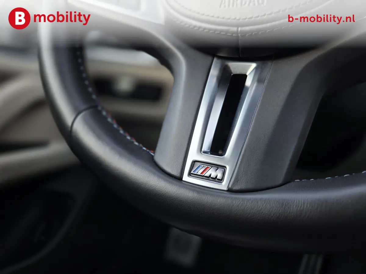 M50 High Executive M-Sport 84 kWh 'Tansanitblau' SOH 96% NL Auto! | 360 Camera | Hifi | DAB | Snelladen | Leer | Head-Up