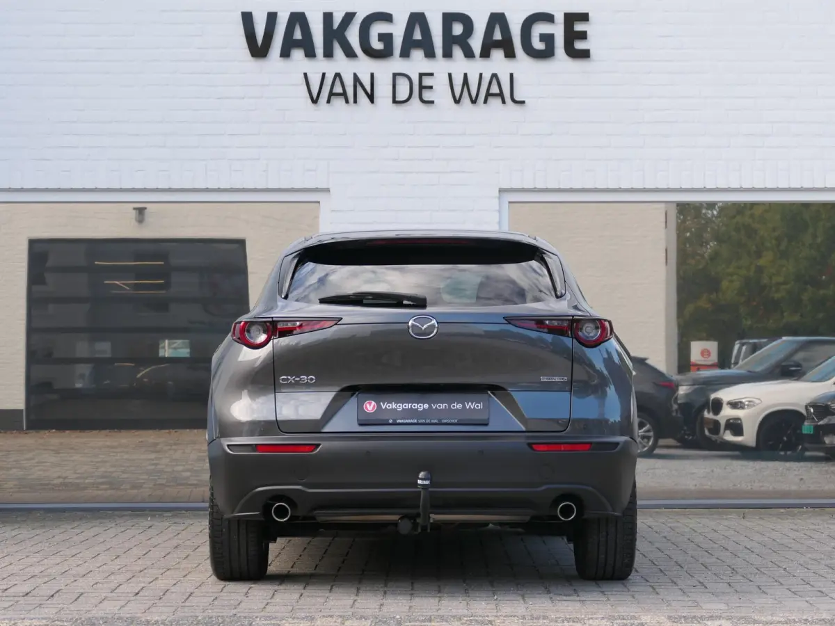 2.0 e-SkyActiv-G M Hybrid Exclusive-line | Trekhaak | Head-up display | Leder | Memory | Elektrische achterklep | Apple-/Android Carplay | Dodehoek detectie | Stuur-/Stoelverwarming | Achter