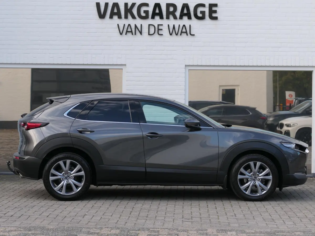 2.0 e-SkyActiv-G M Hybrid Exclusive-line | Trekhaak | Head-up display | Leder | Memory | Elektrische achterklep | Apple-/Android Carplay | Dodehoek detectie | Stuur-/Stoelverwarming | Achter